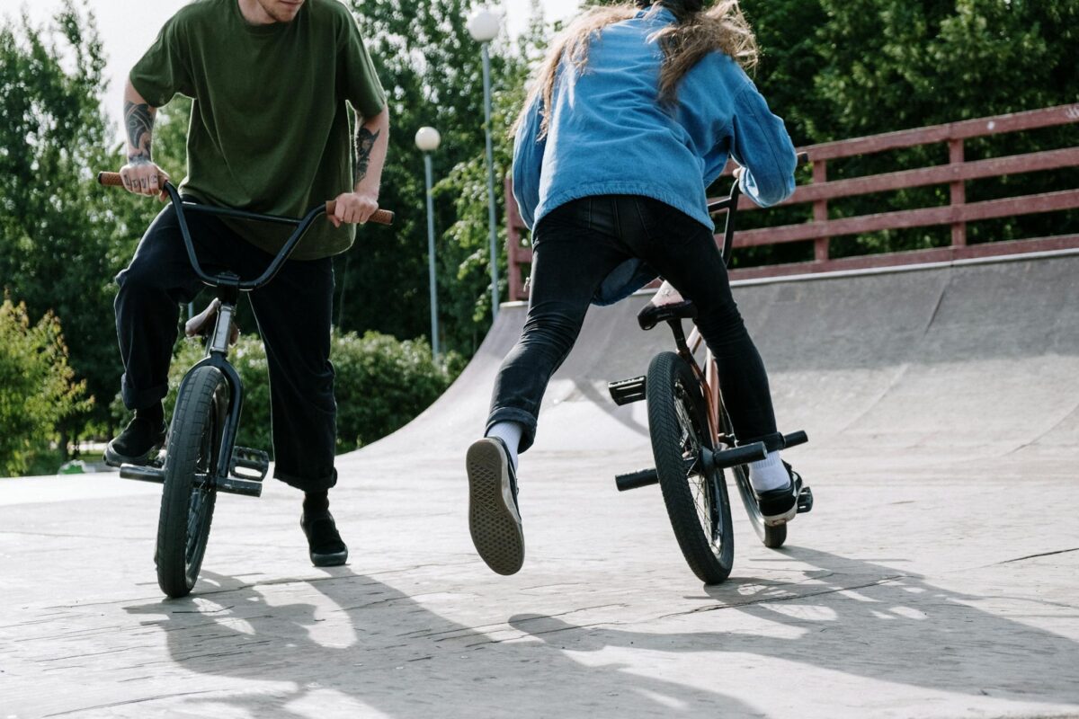 Home 1 two bmx riders performing stunts on their1